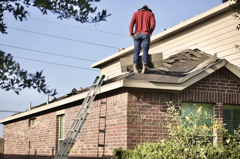 Professional roofer working on a residential roof in Jamesburg Park